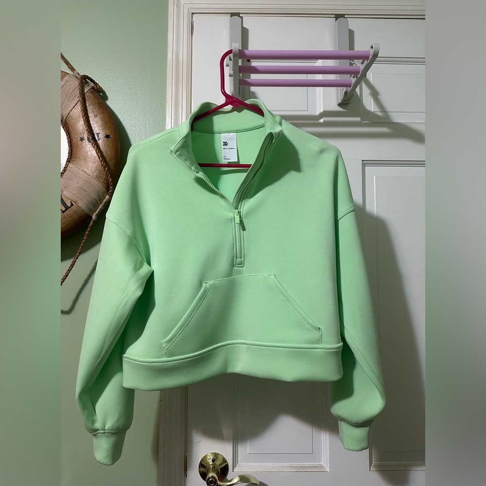 Woman’s light weight pull over sweatshirt in the color neon green